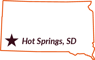 The state of South Dakota outlined in orange with a purple star showing the location of Hot Springs, SD