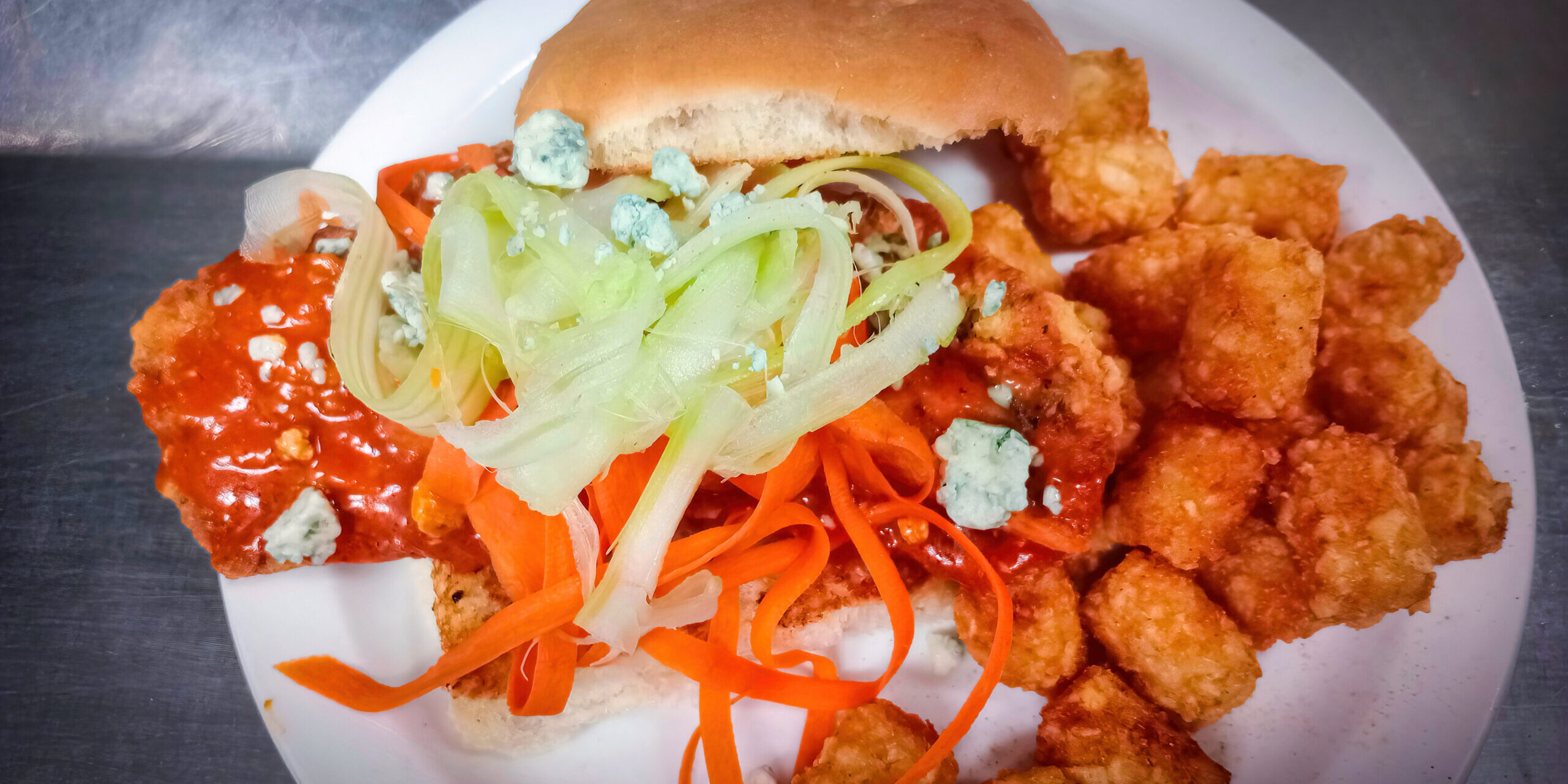 buffalo sandwich with a side of tater tots